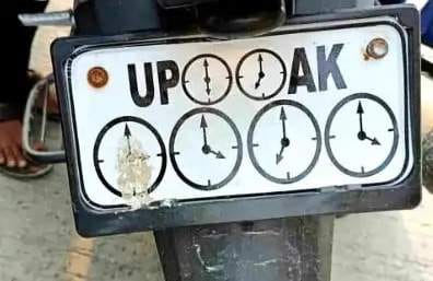 Clock hands on number plate; challan issued.