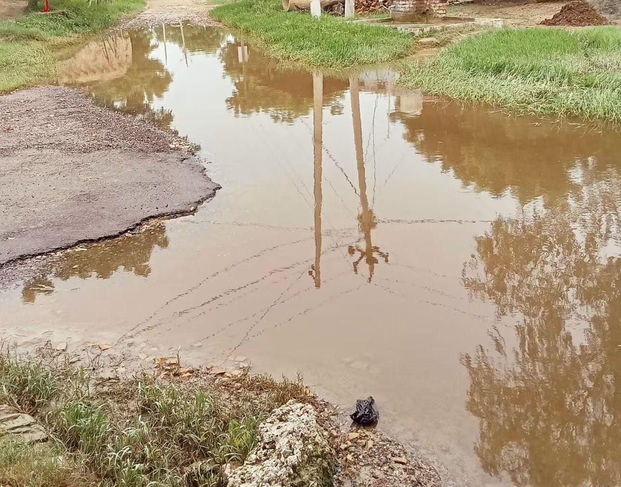 Rainwater filling the potholes on the road