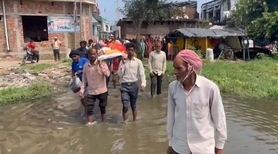 Funeral procession passes through waterlogging and mud; video goes viral.