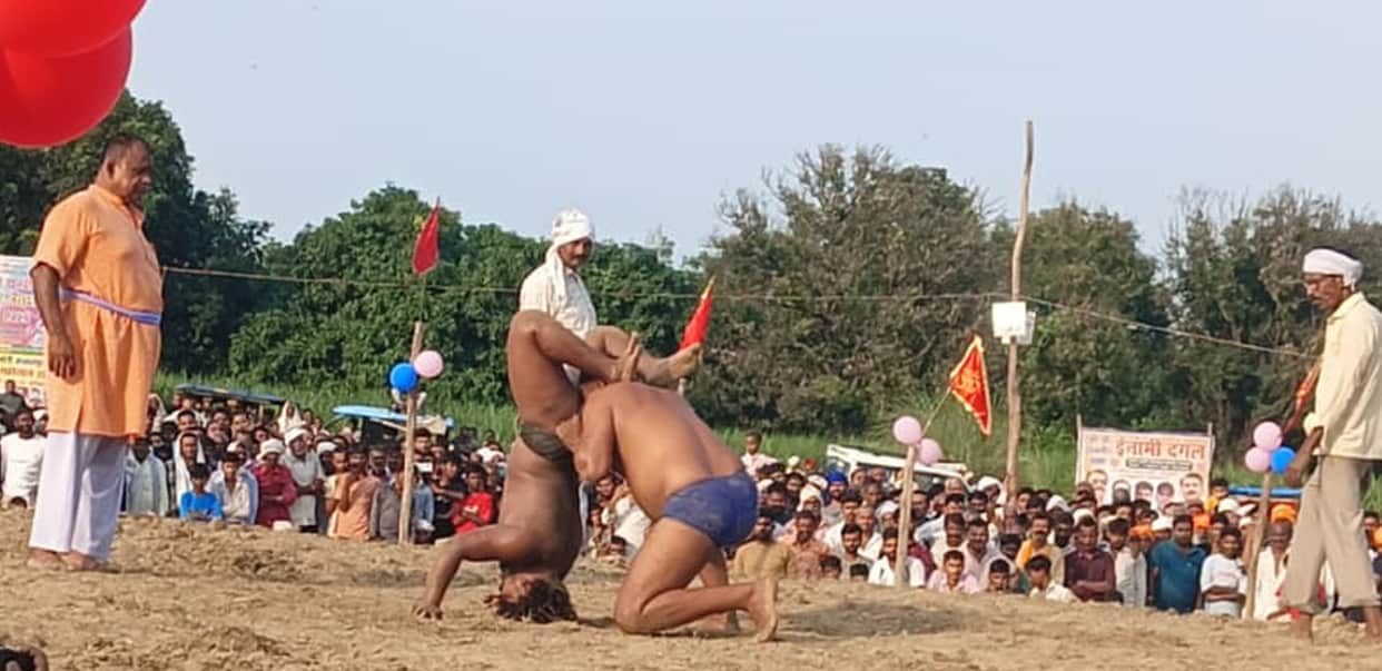 Wrestlers displayed their strength through their moves, and the audience cheered.