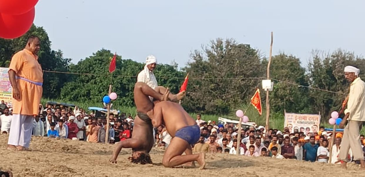 Wrestlers displayed their strength through their moves, and the audience cheered.