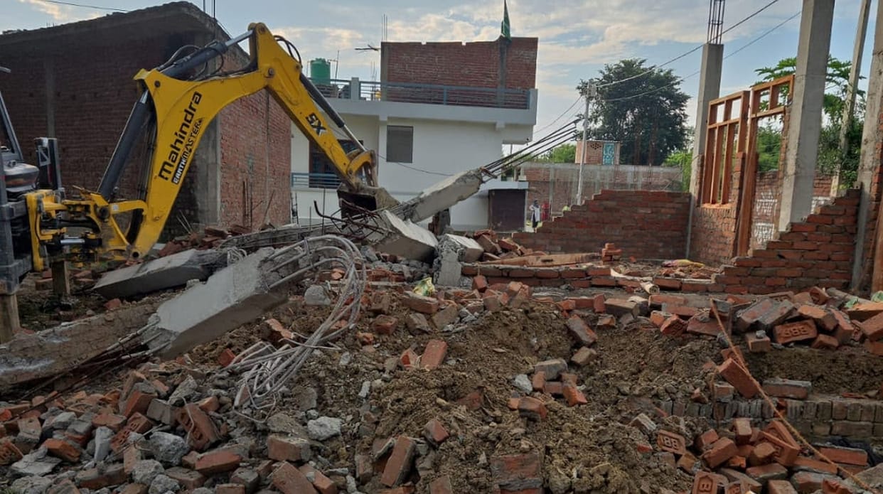 Bulldozer razes illegal construction on protected land.