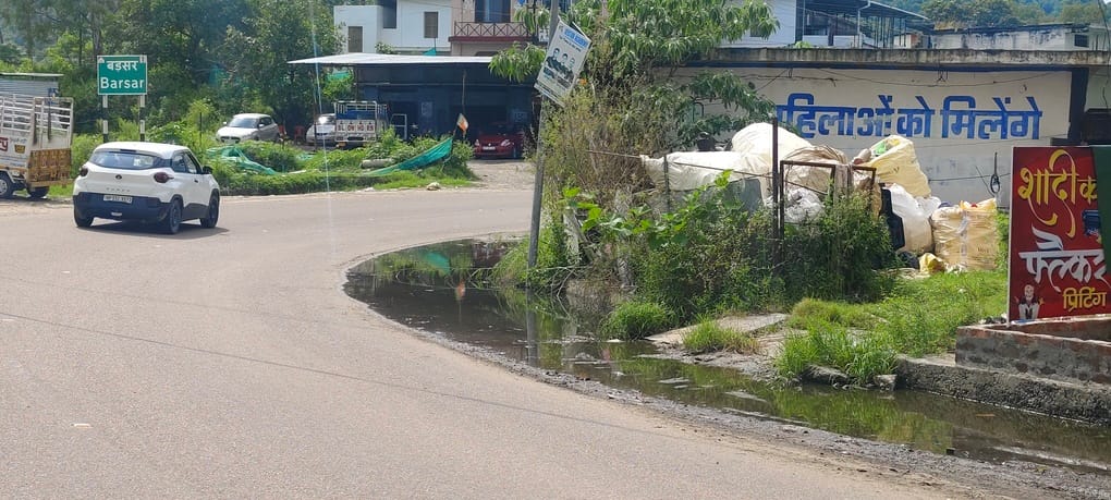 Waterlogging on Mahre-Una Highway; rainwater entering shops.