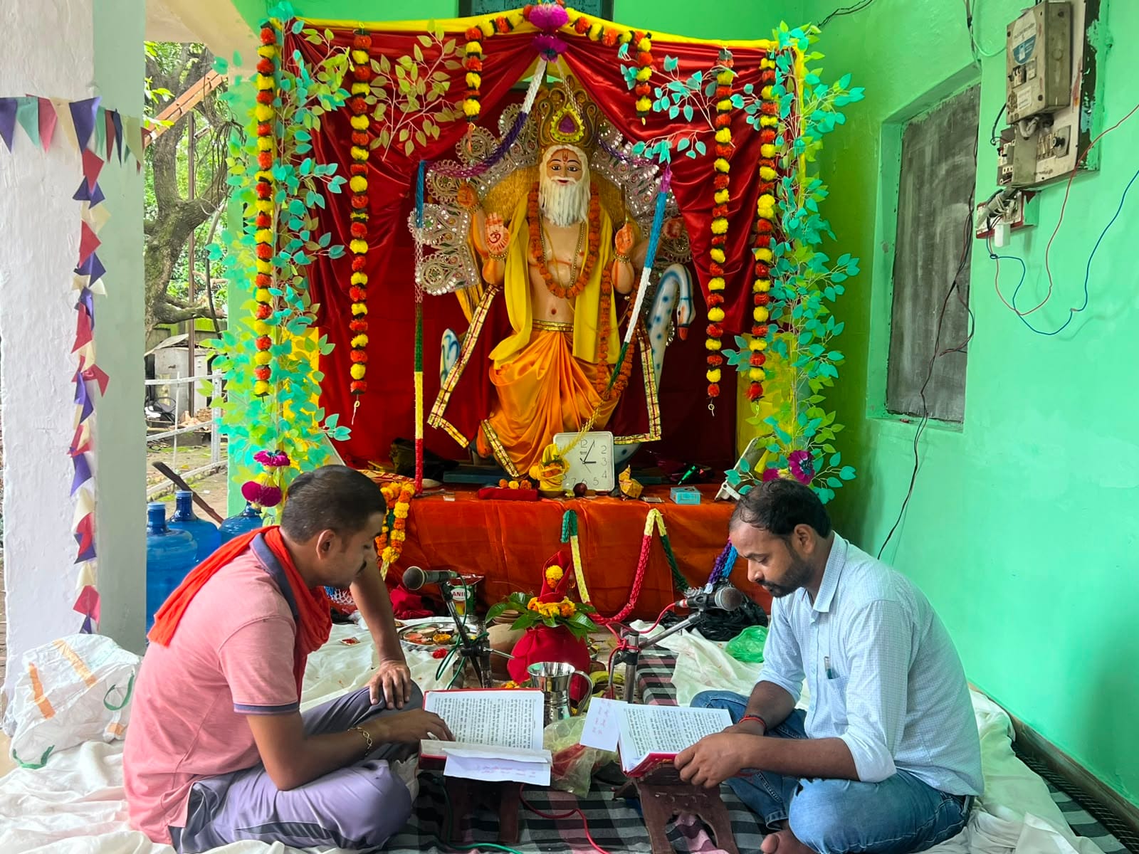रेलवे विभाग कार्यालय में विश्वकर्मा पूजन में स्थापित विश्वकर्मा जी की प्रतिमा, पाठ करते कर्मचार
