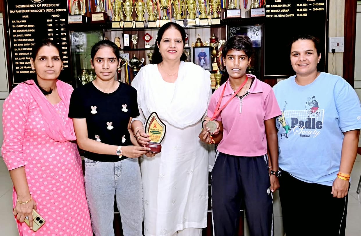 Red Run marathon-winning female students welcomed upon arrival at the college.