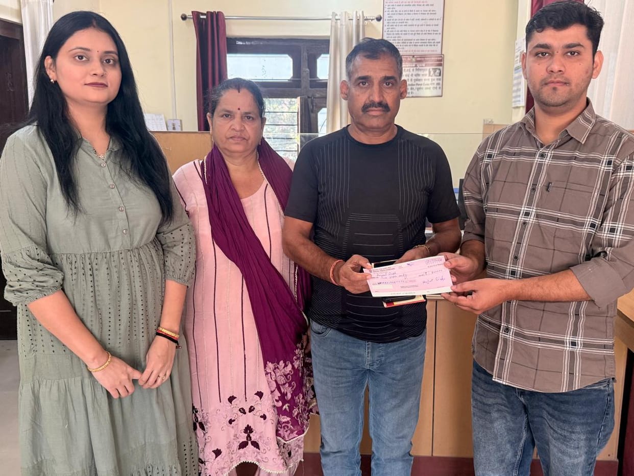 Insurance claim settled; nominated father receives cheque for two lakh rupees.