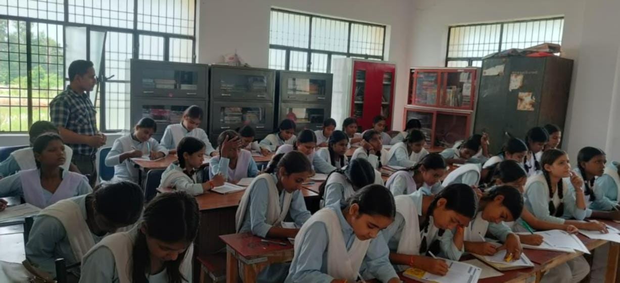 Female students wrote articles during Hindi Week.