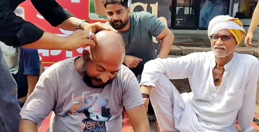 Trader leader sits on hunger strike after shaving head in protest against traffic jams in Bah.