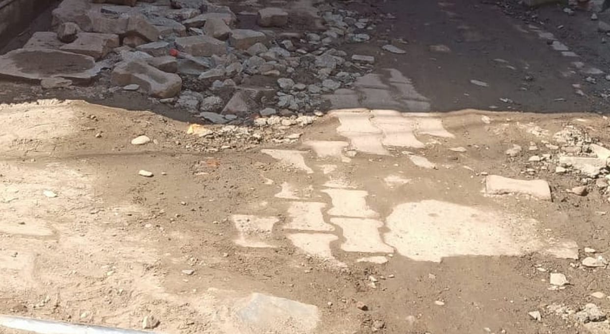 The very first rain exposed the layer of pavers.