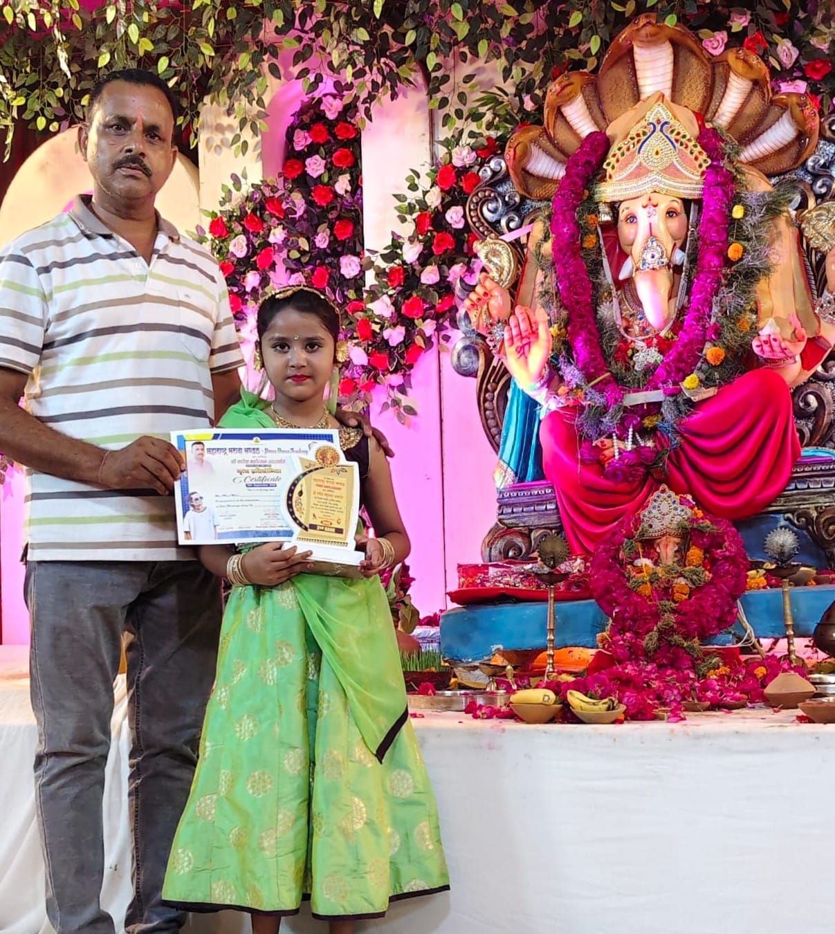 खिरनीबाग धर्मशाला गणेश महोत्सव पर आयोजित कार्यक्रम में बच्ची को पुरस्कृत करते आयोजक। स्रोत: आयो