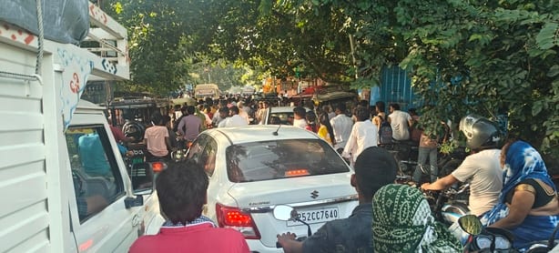 Traffic jam during procession; people stranded.