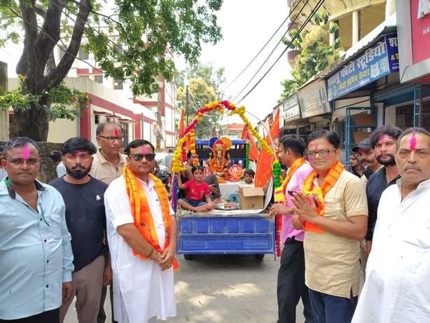 Colors and *gulal* filled the air as the Ganpati idol was given a divine ceremonial bath.