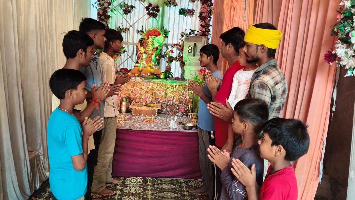 Chants of praise echoed amidst the *gulal* as the Ganesh idol was immersed.