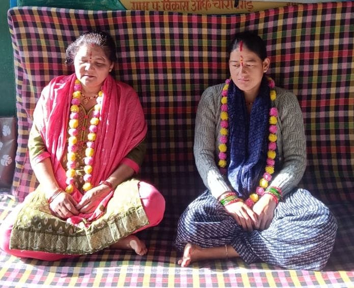 Women left their homes and sat on the road to demand a motorable route.