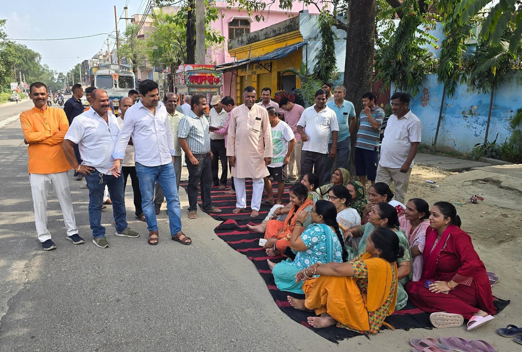 Residents staged a sit-in protest demanding a cut in the divider in front of the temple.