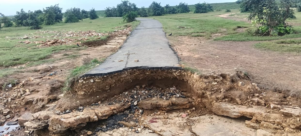 Road washed away in the rain; a pit up to five feet deep formed