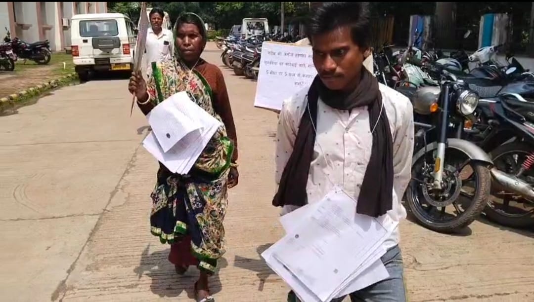 With placards around their necks, applications in hands and hope in eyes, tribal family arrived public hearing