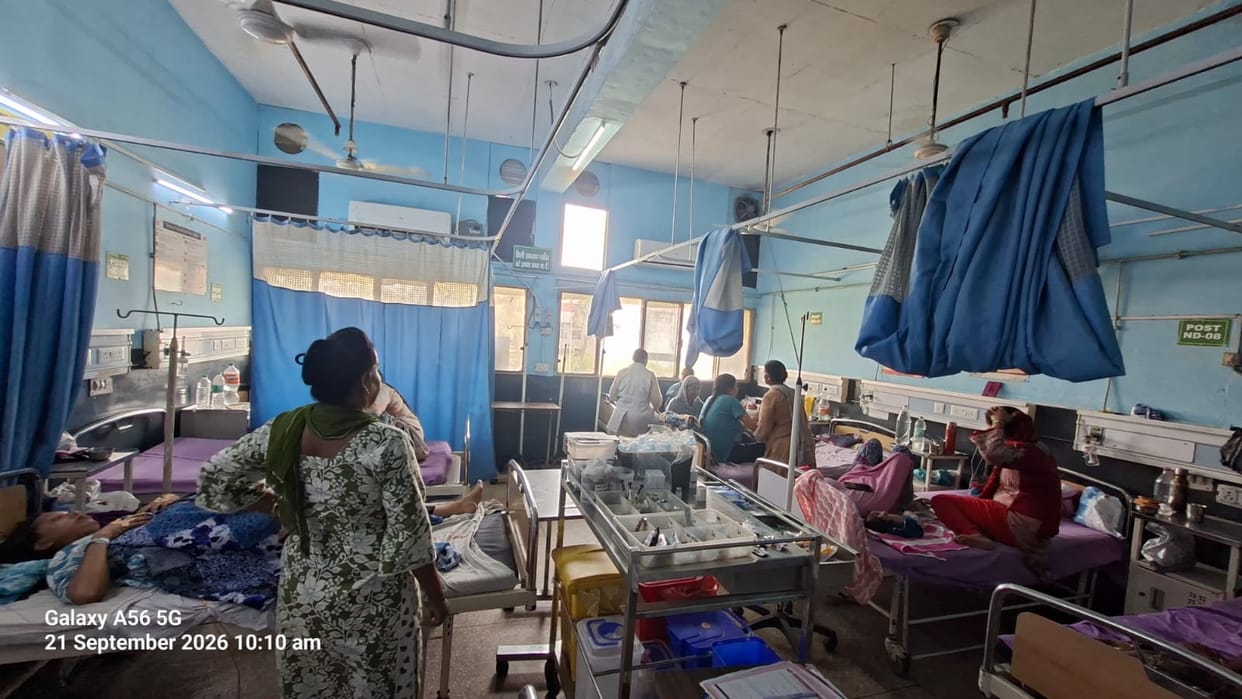 With the AC turned off, new mothers are fanning their newborns with hand fans.
