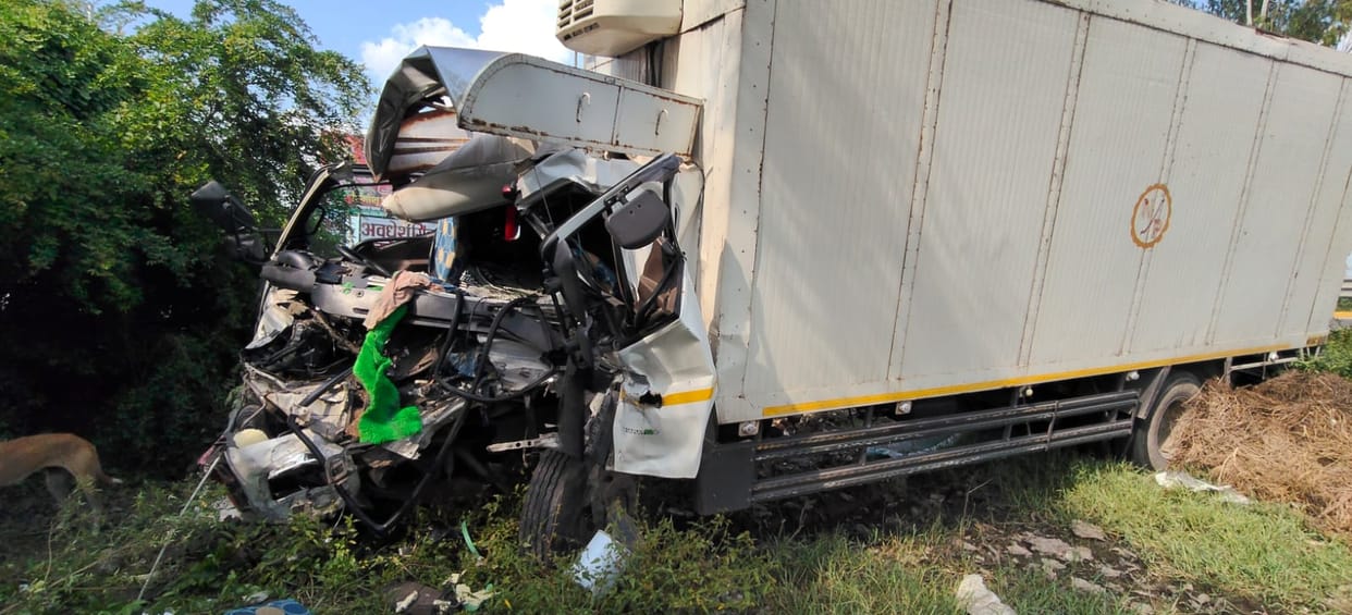 Truck crashes into tree and overturns into a ditch; two injured.