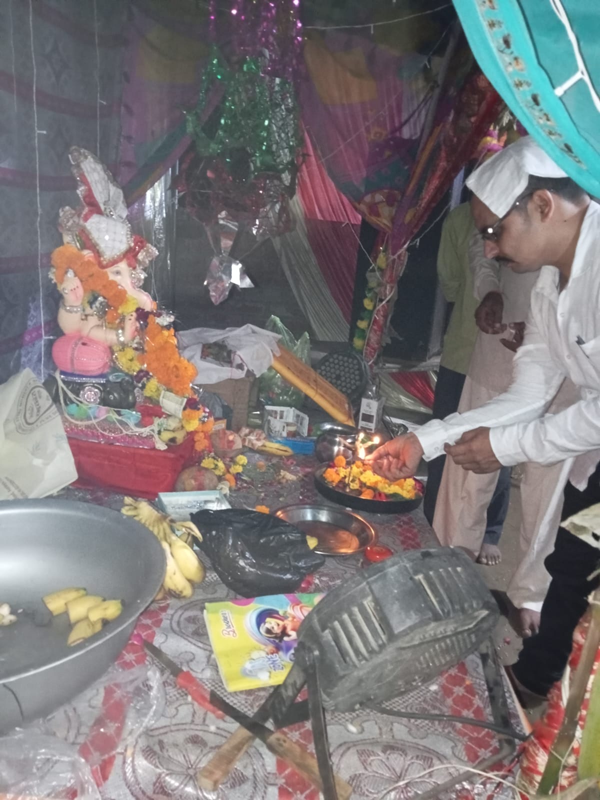 Bappa bid farewell amidst chants; devotees thronged the community feast.
