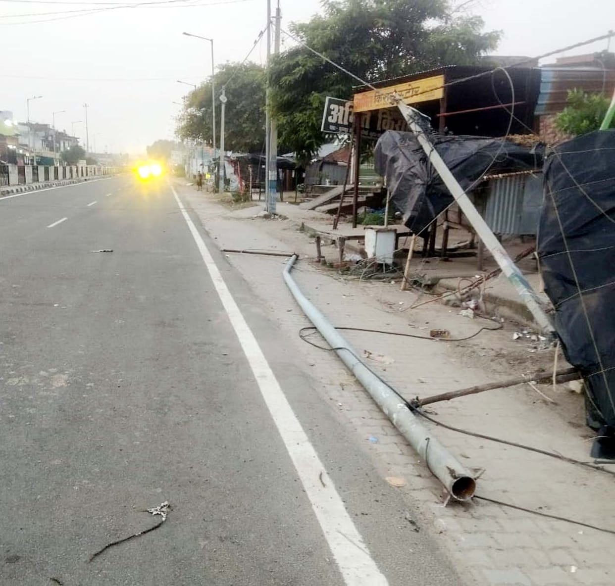 Two electricity poles snapped after getting caught in a dumper; major accident averted.