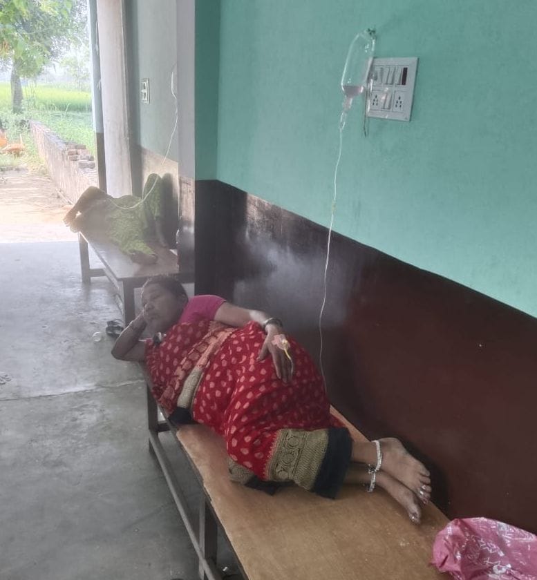 Beds lie empty in government hospitals, while patients in private hospitals receive IV drips while sitting on benches.