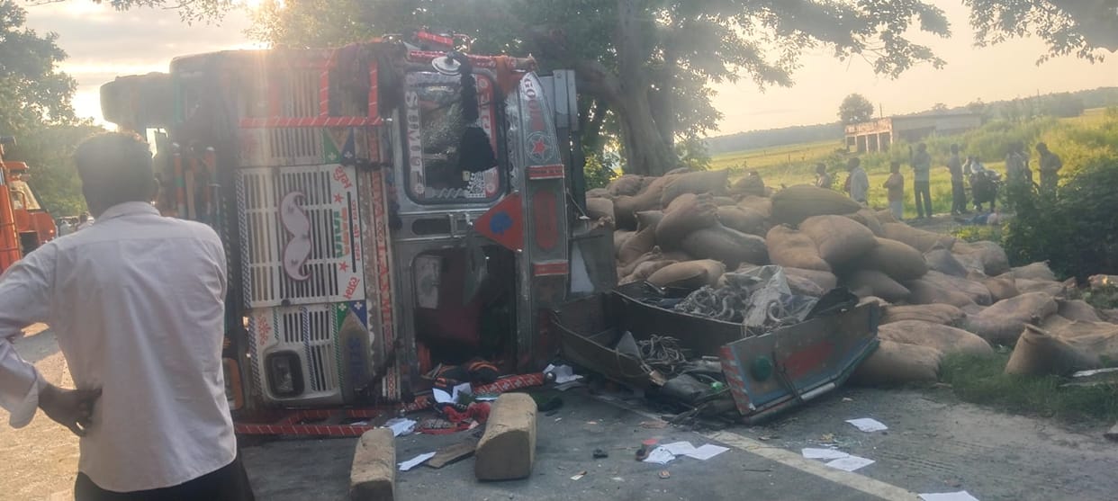A truck carrying paddy overturned, causing a two-km traffic jam on the Assam highway.