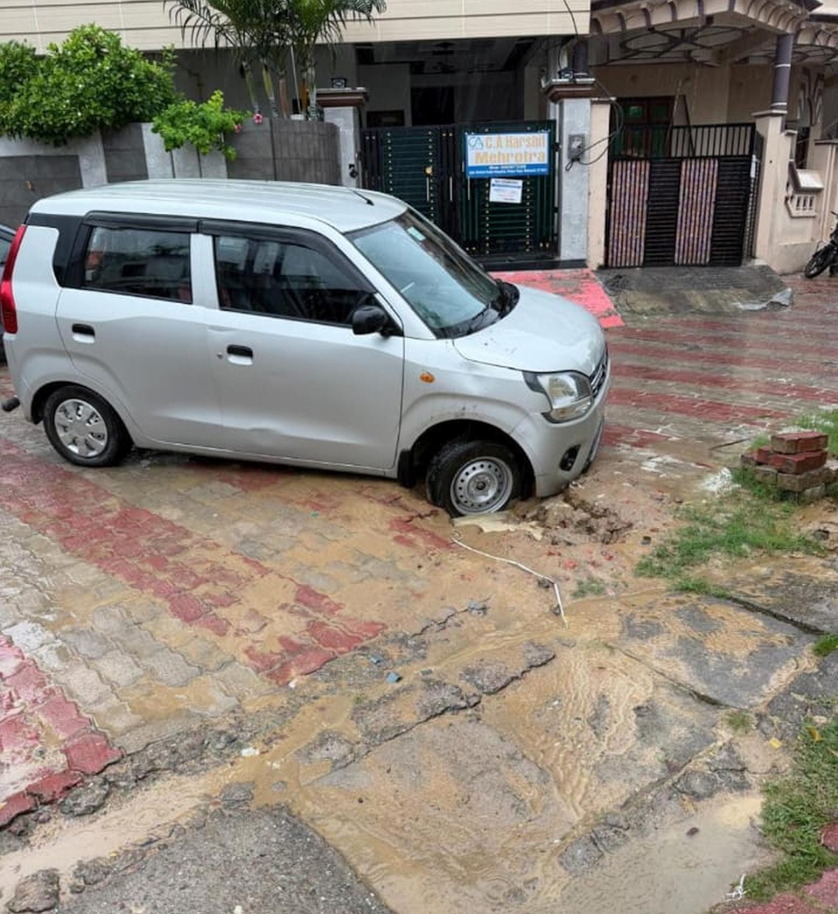 रायपुर राजा में गैस पाइपलाइन के लिए खोदे गए गड्ढे में फंसी कार।