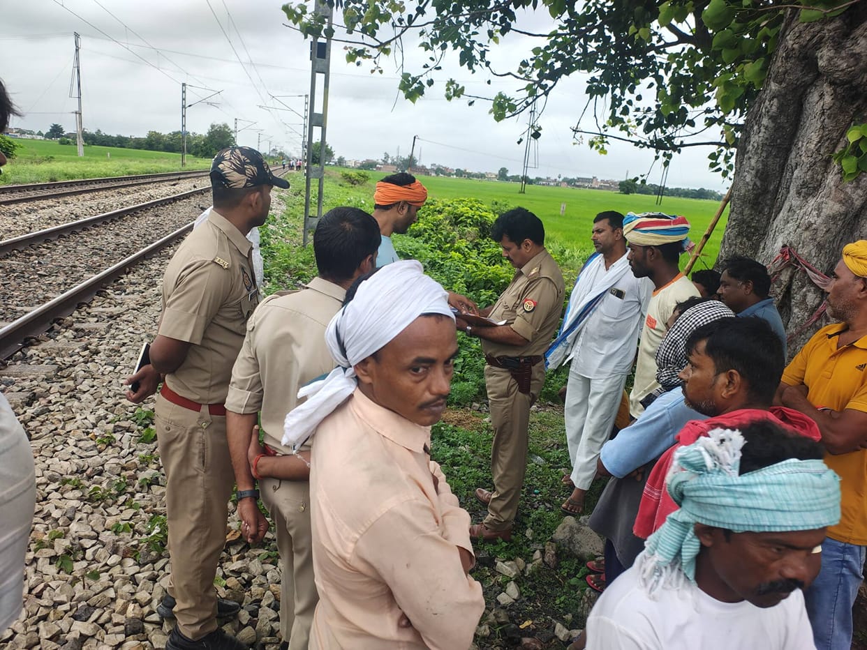 Two laborers walking home along the railway tracks died after being struck by a train.
