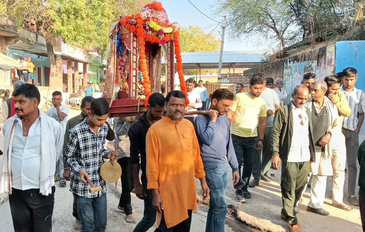 Deities' chariots taken out in procession at the Jalvihar Fair; flowers showered upon them.
