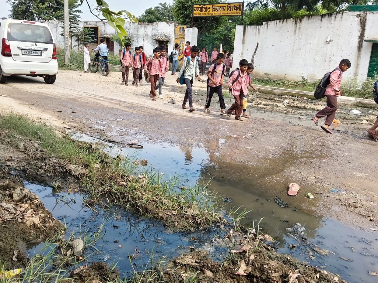 Water flowing on roads due to lack of cleaning; school children facing difficulties.