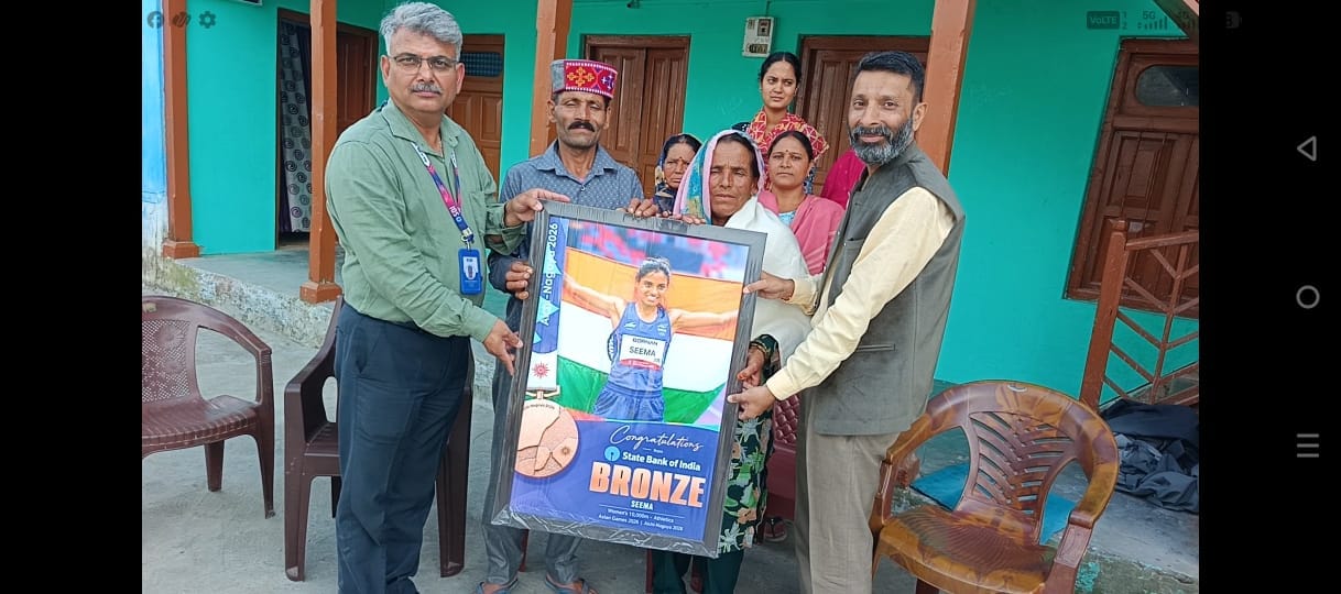 Bronze medalist Seema's family honored at school.