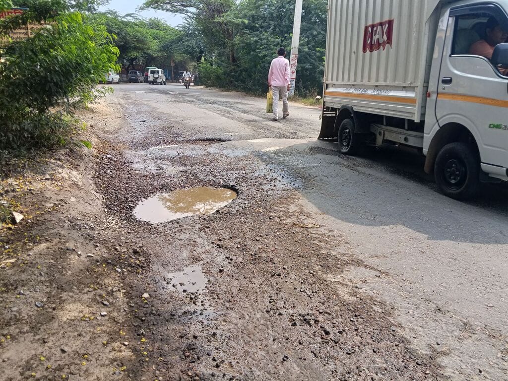 Waterlogging caused by a broken water line in front of the school gate.