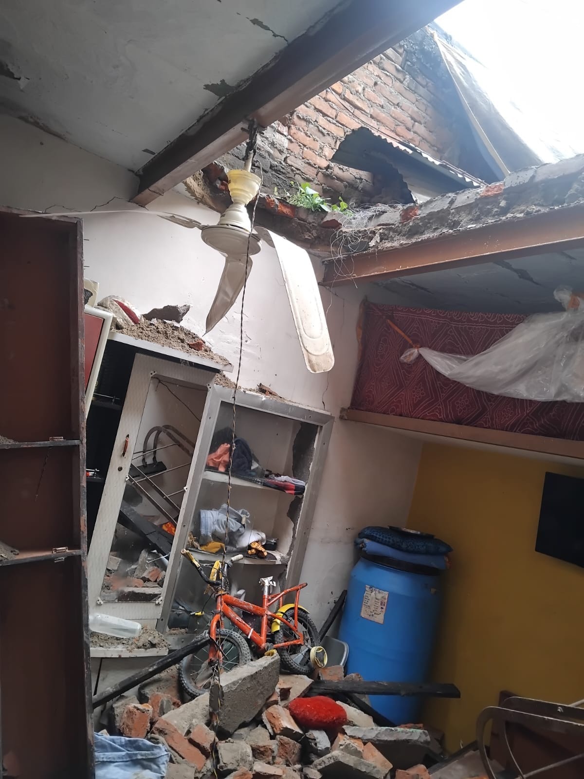 House roof collapses in rain; five injured after being trapped under debris.