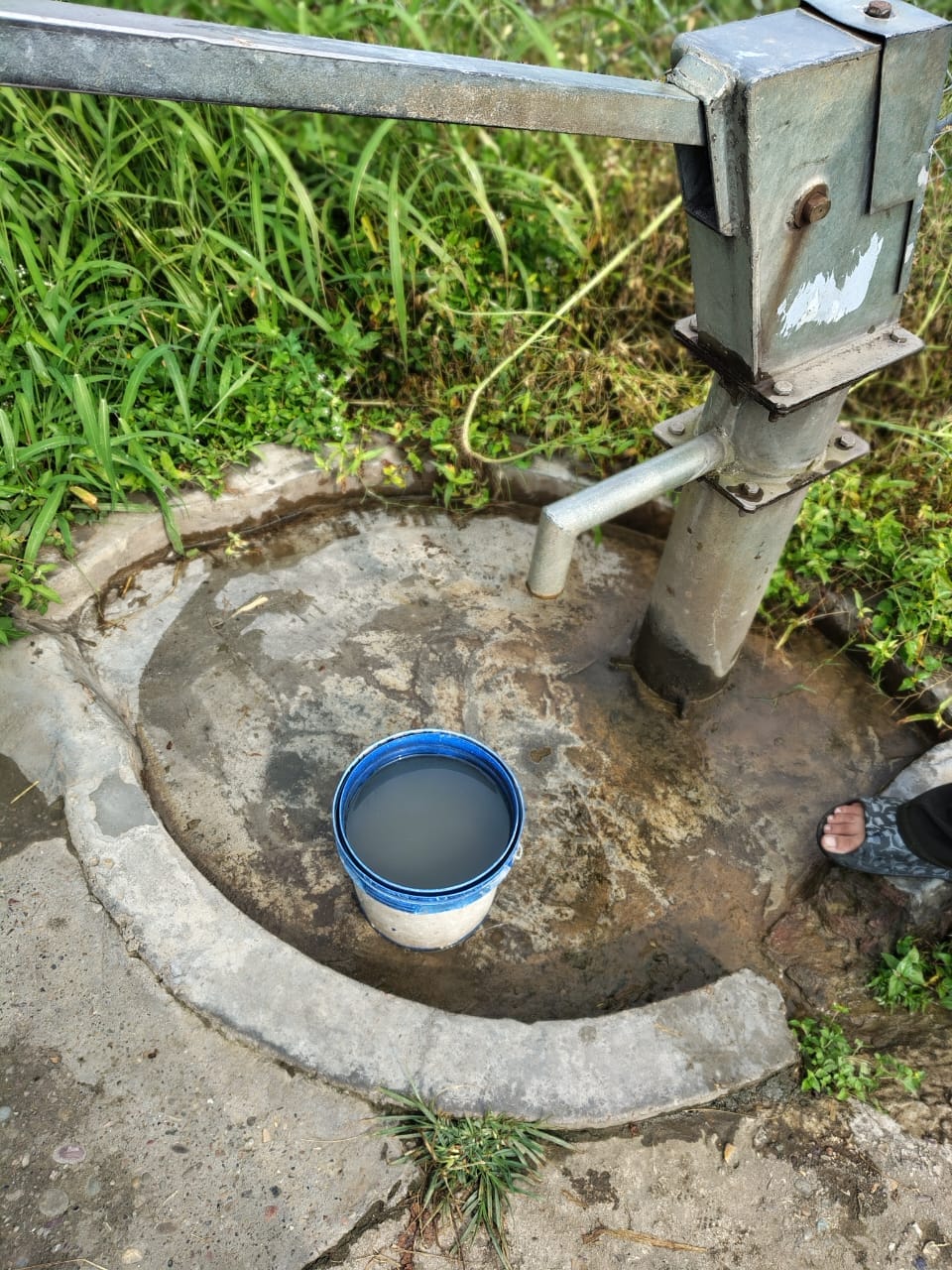 Muddy water flowing from a public handpump in Lanjhata.