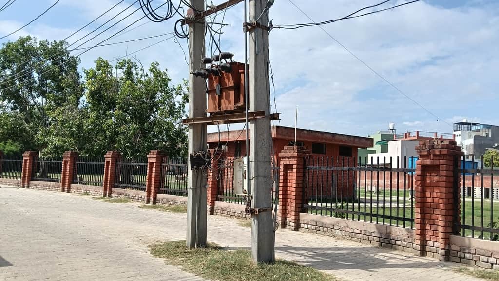 Seven electricity poles and two transformers standing in the middle of the street are obstructing movement