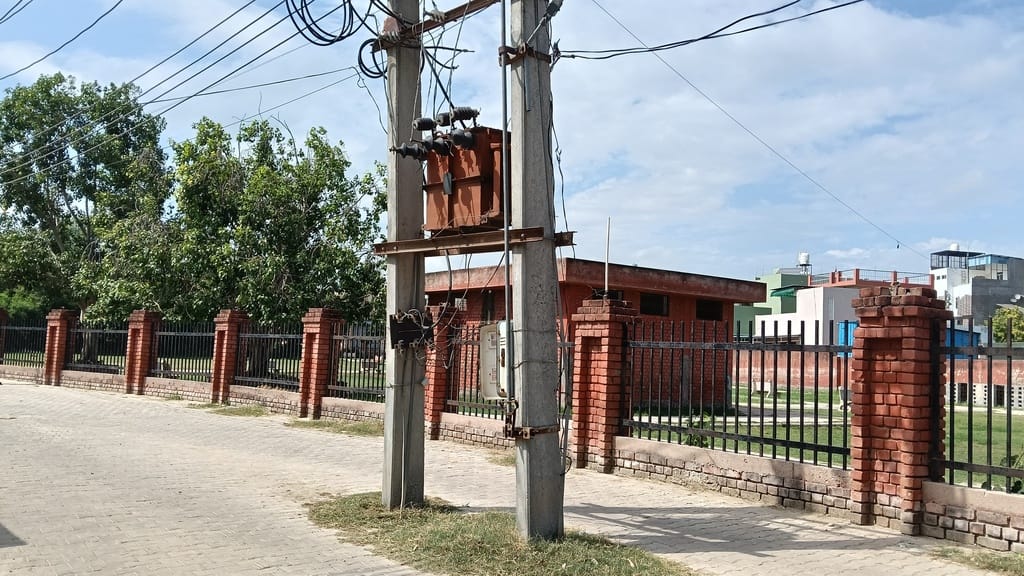 Seven electricity poles and two transformers standing in the middle of the street are obstructing movement