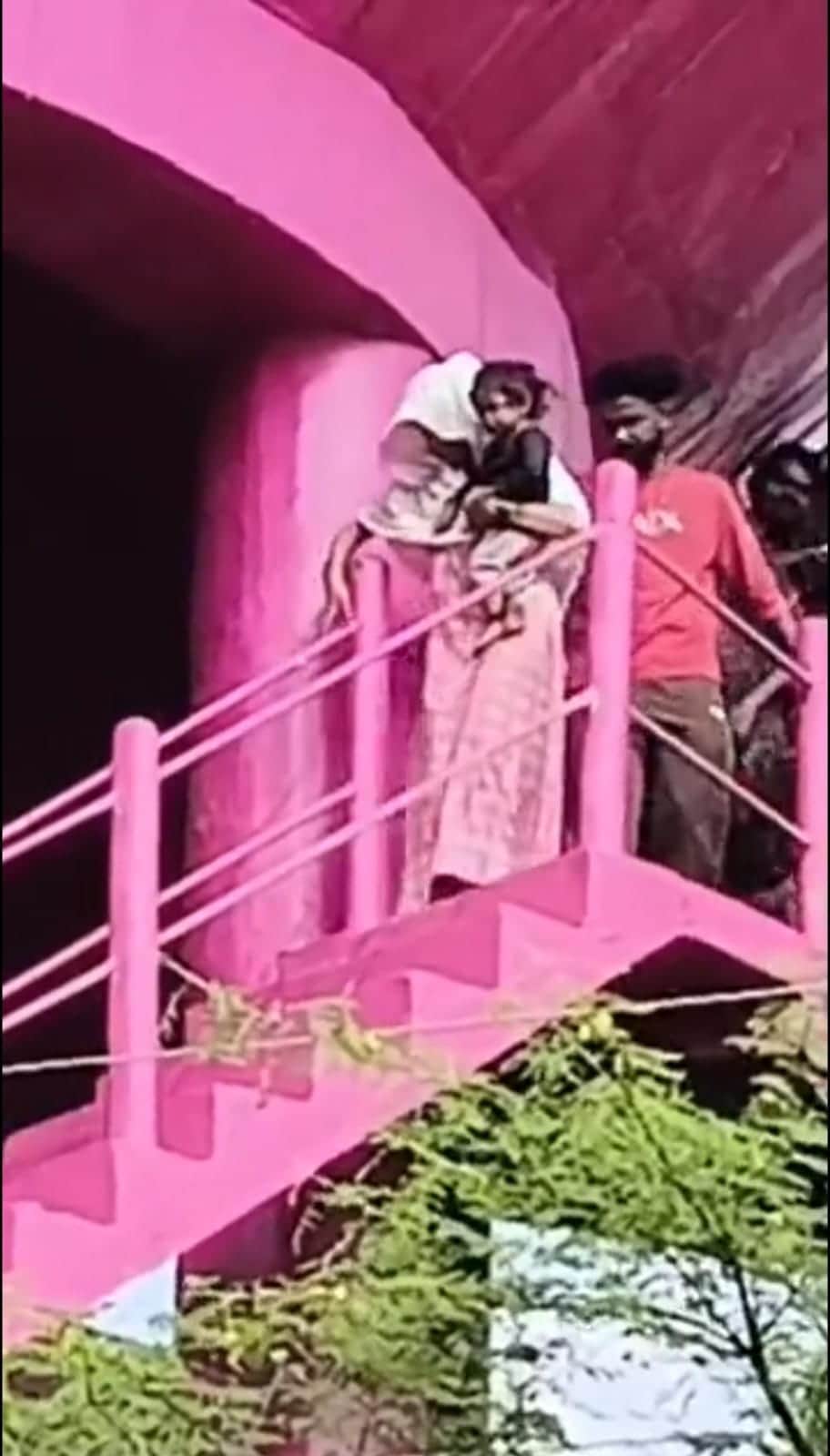 Family climbs atop water tank, protests with 9-month-old baby