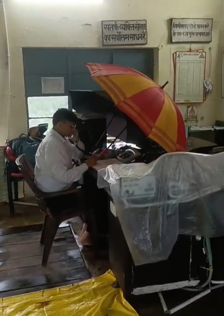 Duty performed under an umbrella in the Dilkusha cabin; railway equipment covered with plastic sheets.