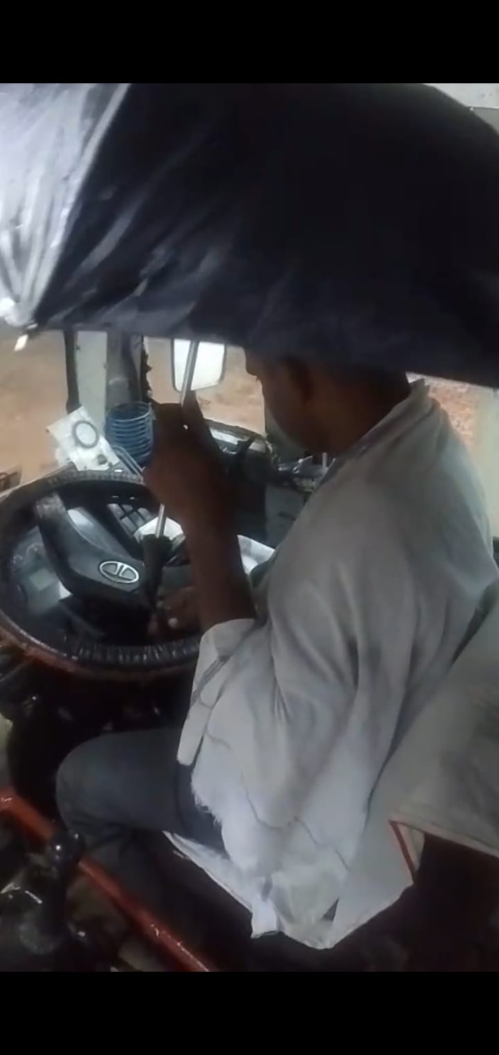 Water dripped inside the roadways bus, so the driver put up an umbrella.