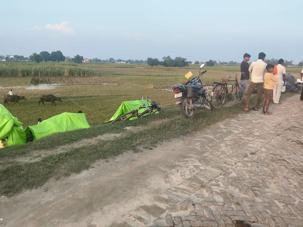 Villagers rattled by the surging Saryu; taking shelter on the embankment.