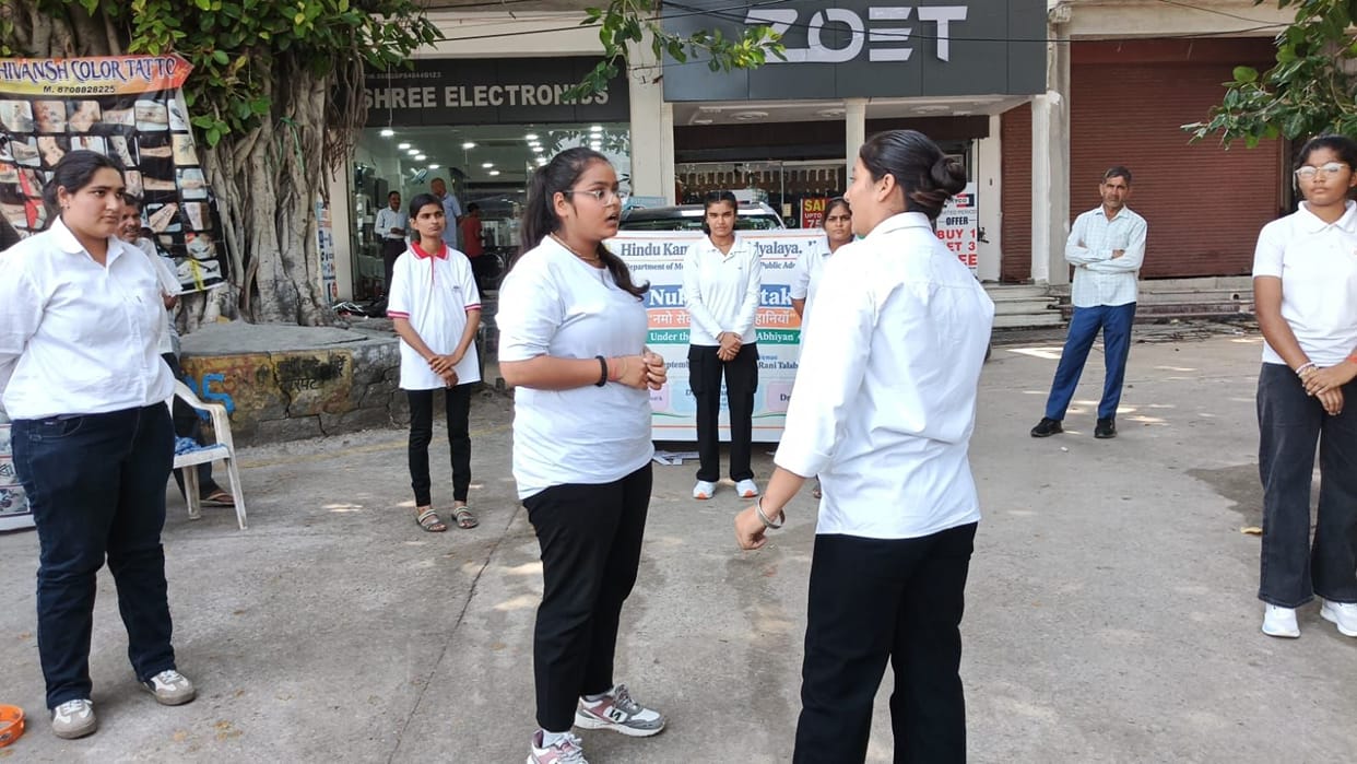 Female students raised awareness about government schemes through a street play.