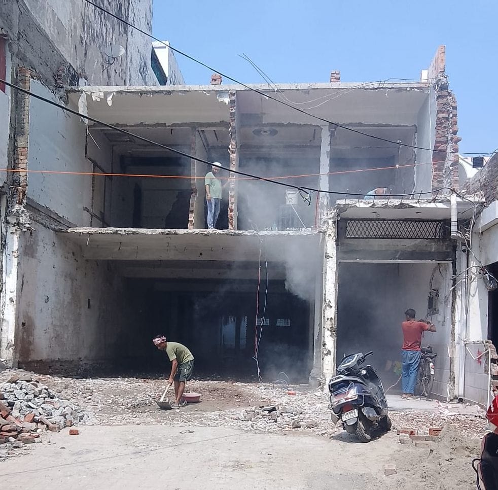 Fearing the bulldozer, 56 encroachers started wielding hammers themselves.