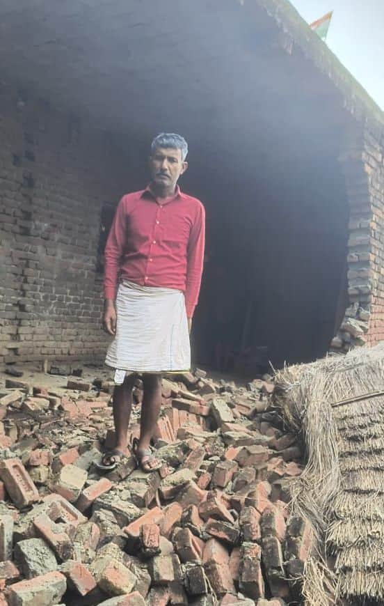 Water enters several homes in Sakatpur village; belongings placed on cots and wooden platforms.