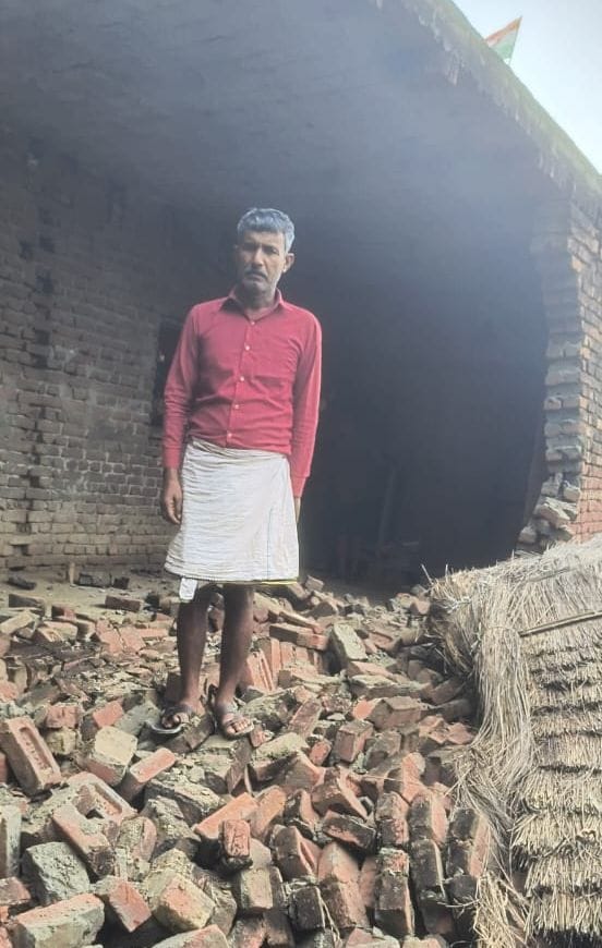 Water enters several homes in Sakatpur village; belongings placed on cots and wooden platforms.