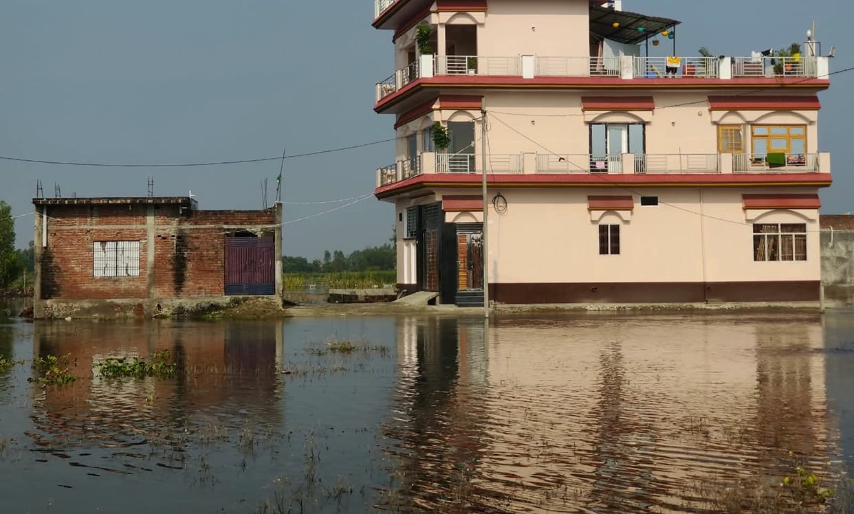 A week later, homes remain flooded, roads infested with crocodiles