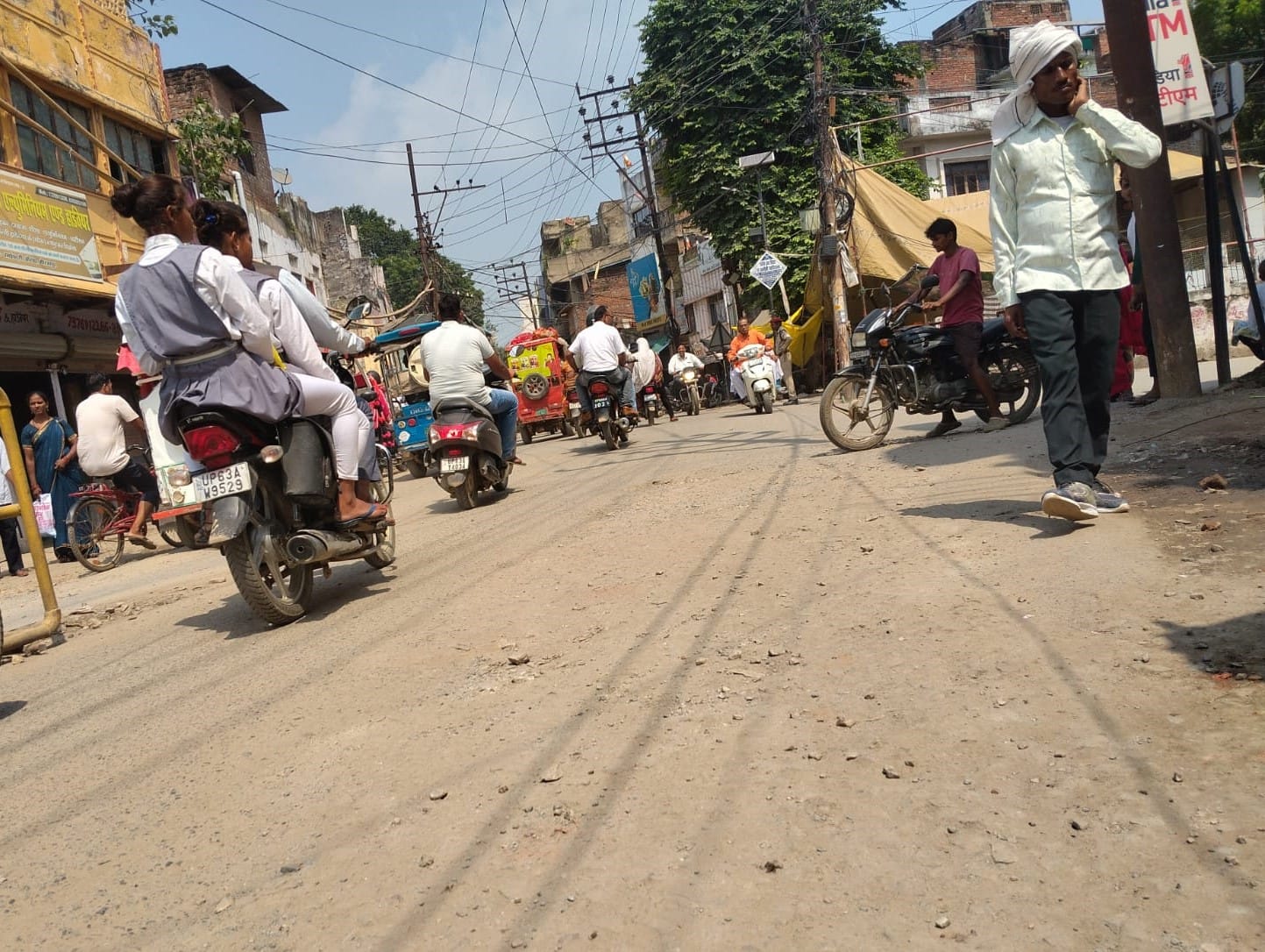 तेज धूप में कचहरी-रमईपट्टी मार्ग पर गुजरते राहगीर।- संवाद।
