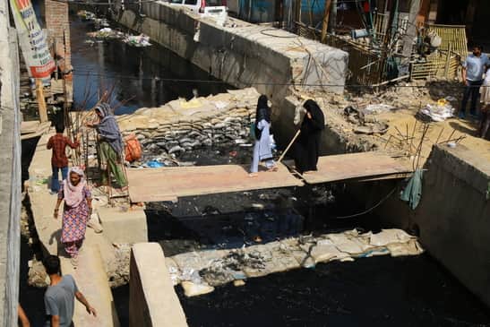 Culvert broken for six months; life's journey across wooden planks.