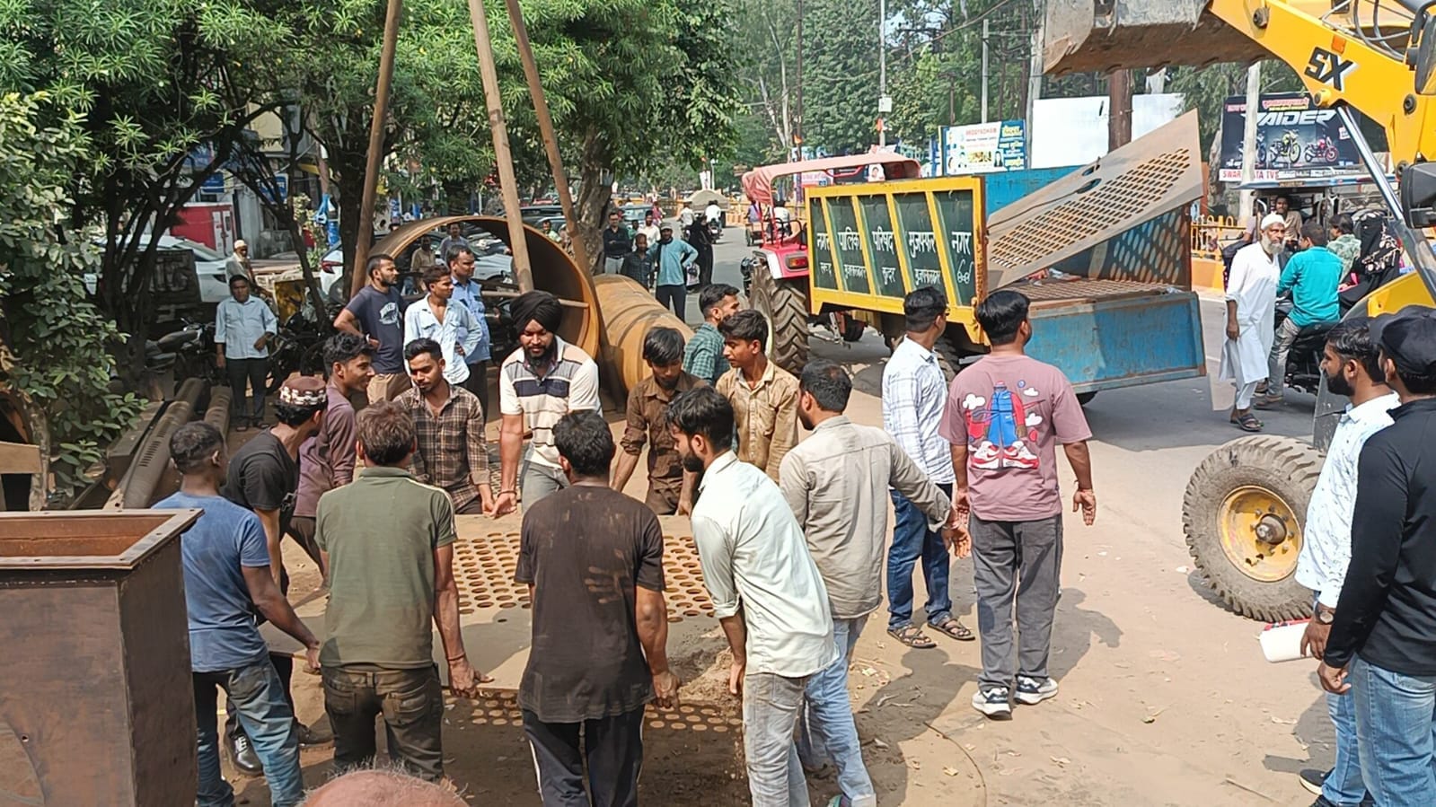 अतिक्रमण कर सड़क पर रखे गए सामान को उठाते फैक्ट्री कर्मी। स्रोत- नगर पालिका