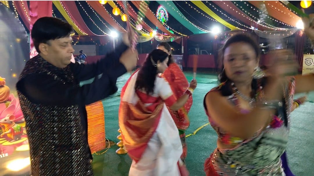 Dandiya Night celebrations in full swing at Argora Ground during Durgotsav; devotees sway to devotional songs.